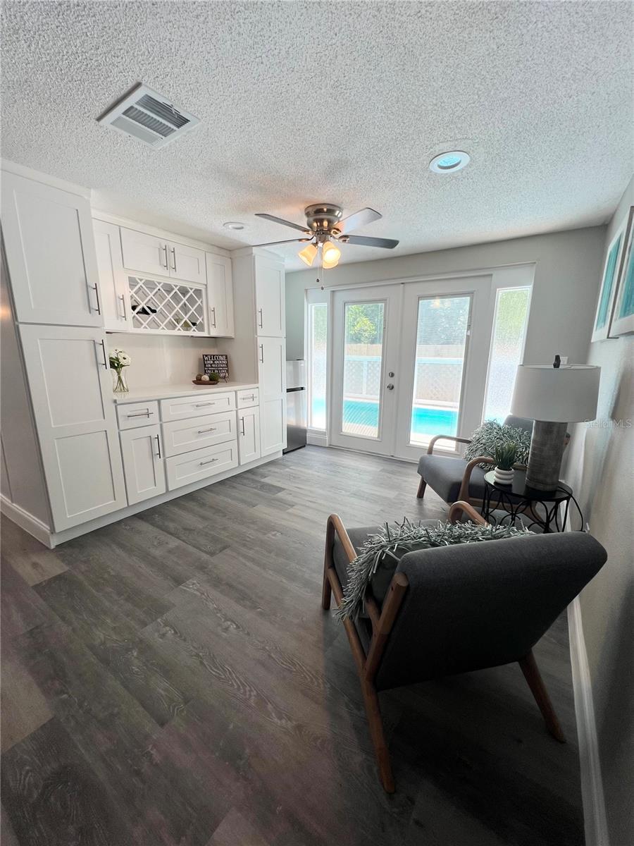 FAMILY ROOM, DRY BAR, FRENCH DOORS VIEW FROM HALL