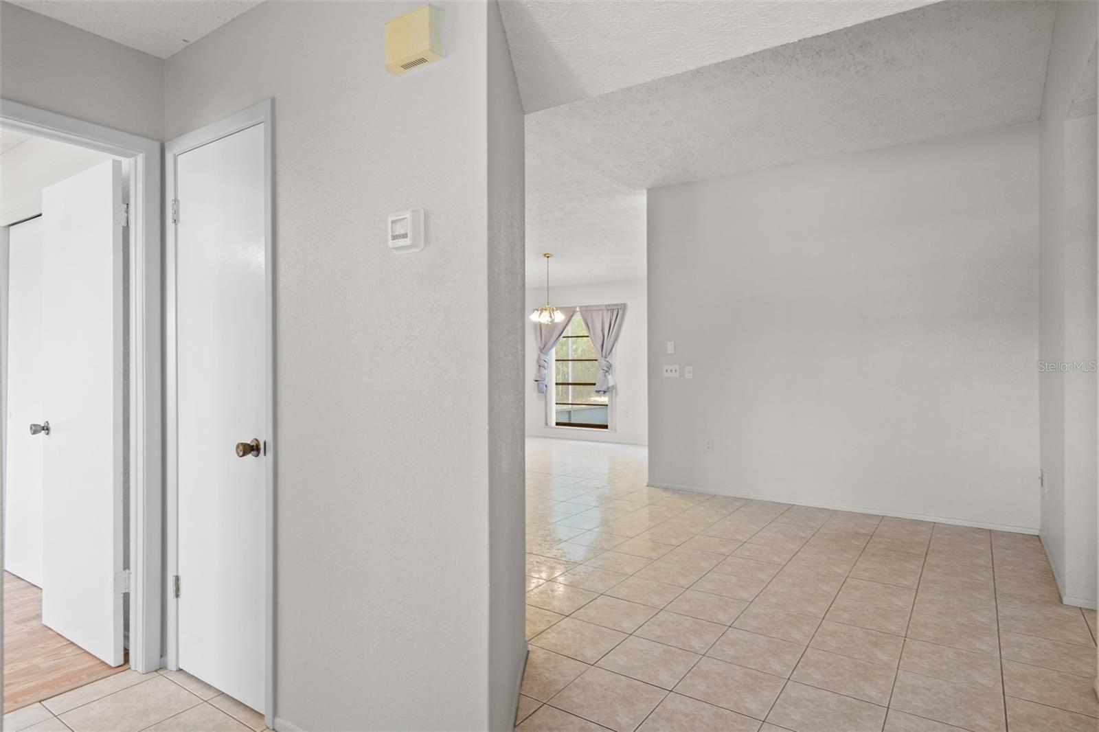 Entry to guest bedroom left, living/dining room straight ahead