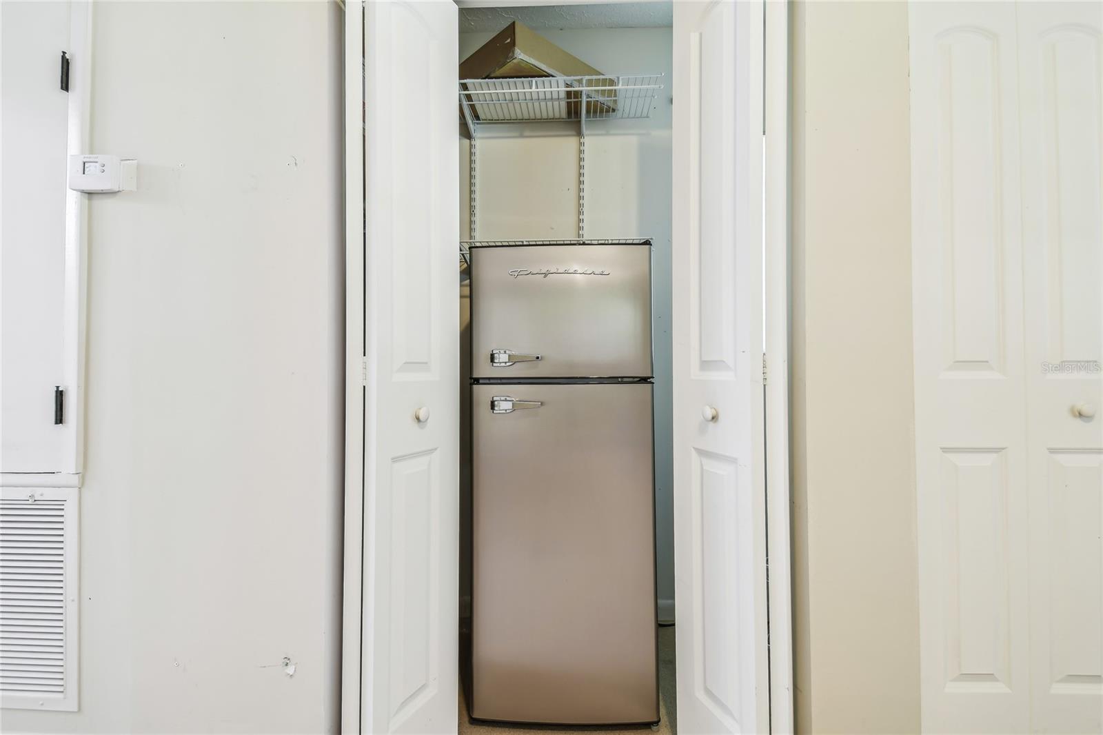 Closet kitchenet with fridge and microwave