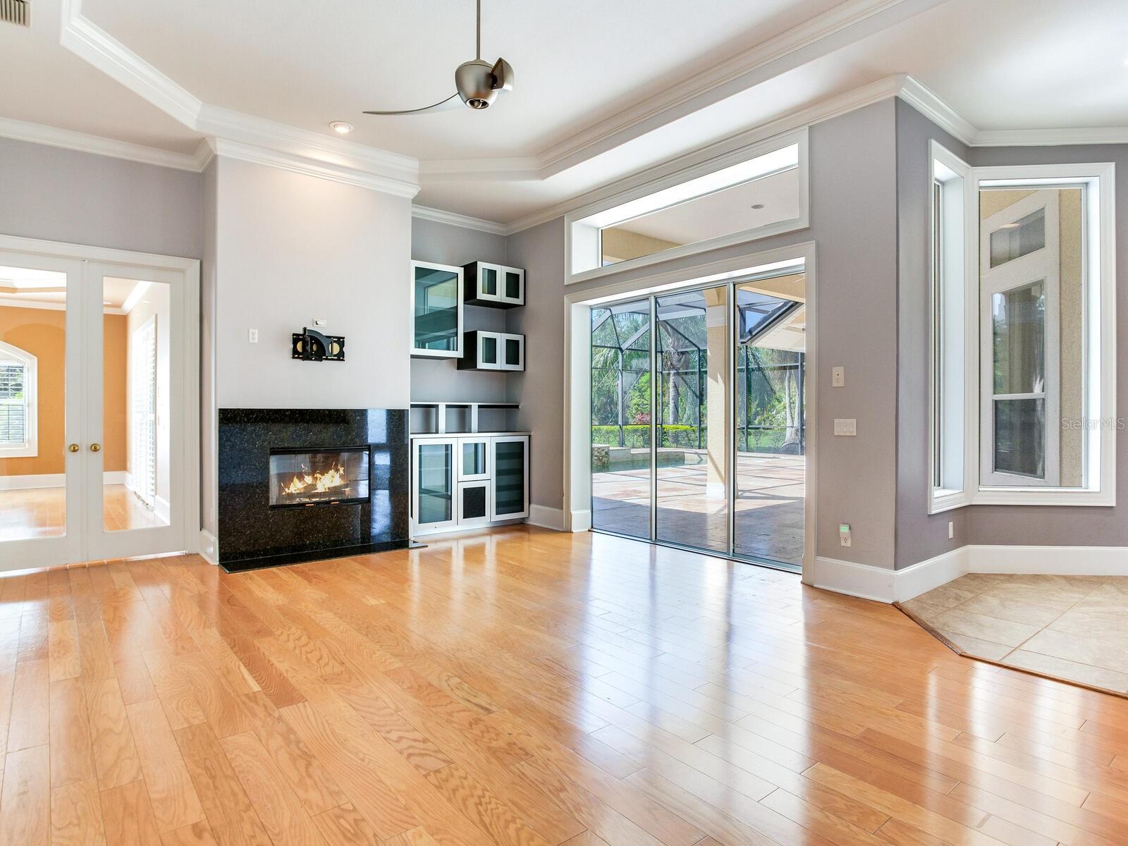 Great Room / Coffered Ceiling / Crown Molding / Fireplace
