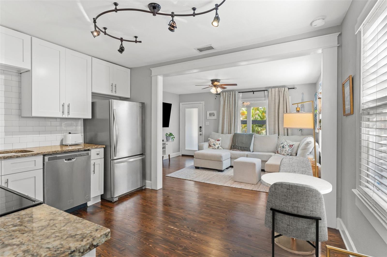 Virtually staged to show where you can fit a bistro dining set. Alternatively, can add a small island with space for two chairs!
