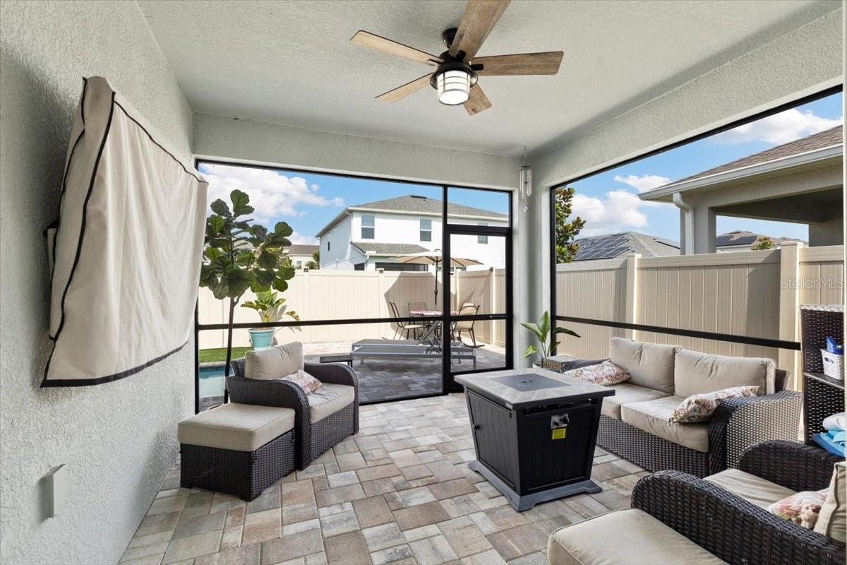 Screened lanai featuring a mounted TV