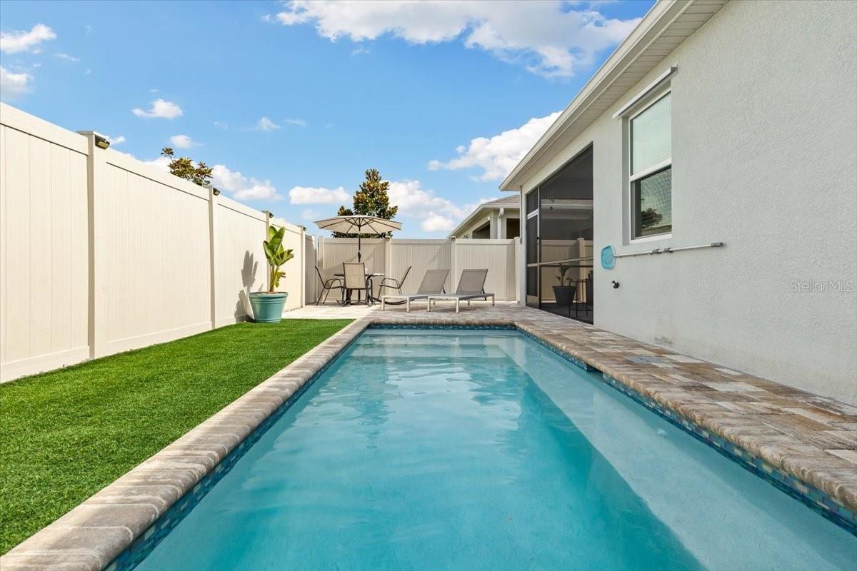 Private pool featuring a waterfall feature