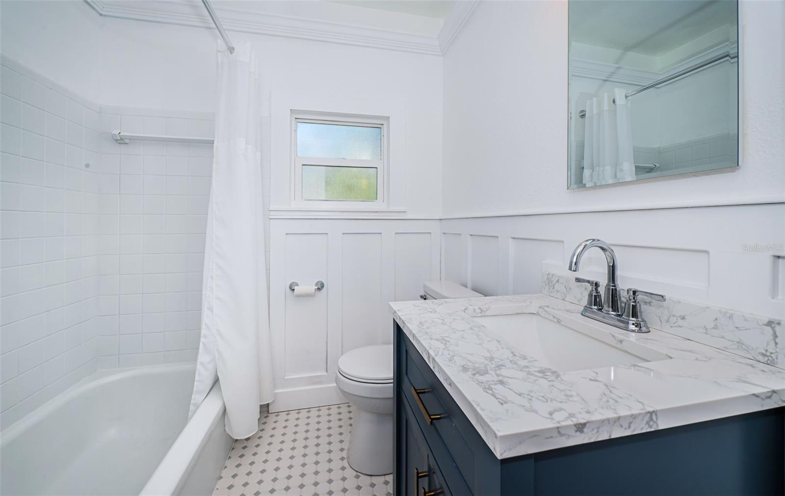 Sweet hall bathroom with coastal elegance.