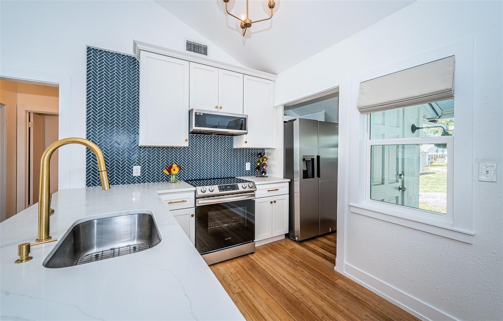 Stunning remodel of the kitchen provides space to entertain inside and out!