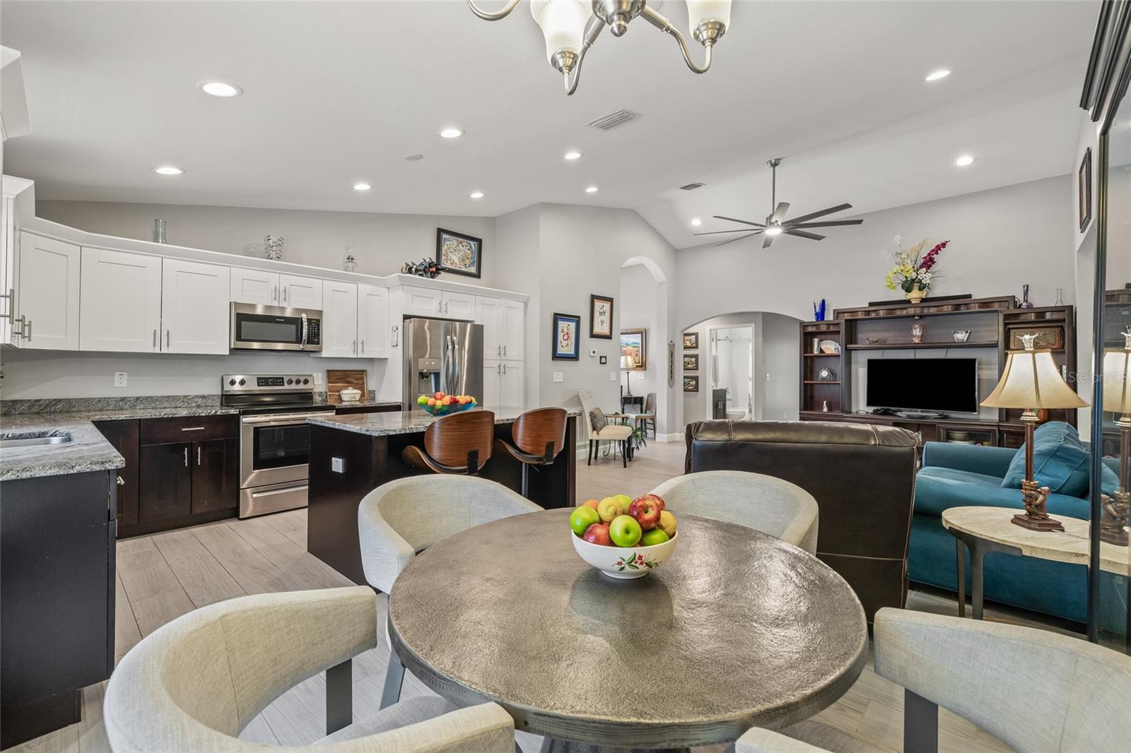 The heart of the home boasts an open layout, modern ceiling fan, and recessed lighting, creating an inviting space to relax or gather with loved ones.
