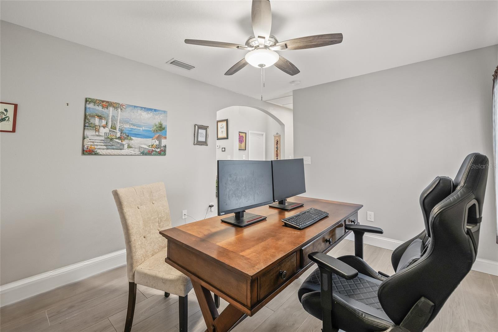 Set up with dual monitors and plenty of space, the den makes an ideal home office or creative studio.