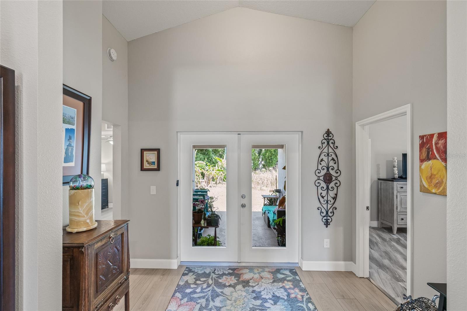 Elegant glass doors open to a large backyard—ready for a garden, firepit, or even your dream pool with peaceful views of Orchid Lake.