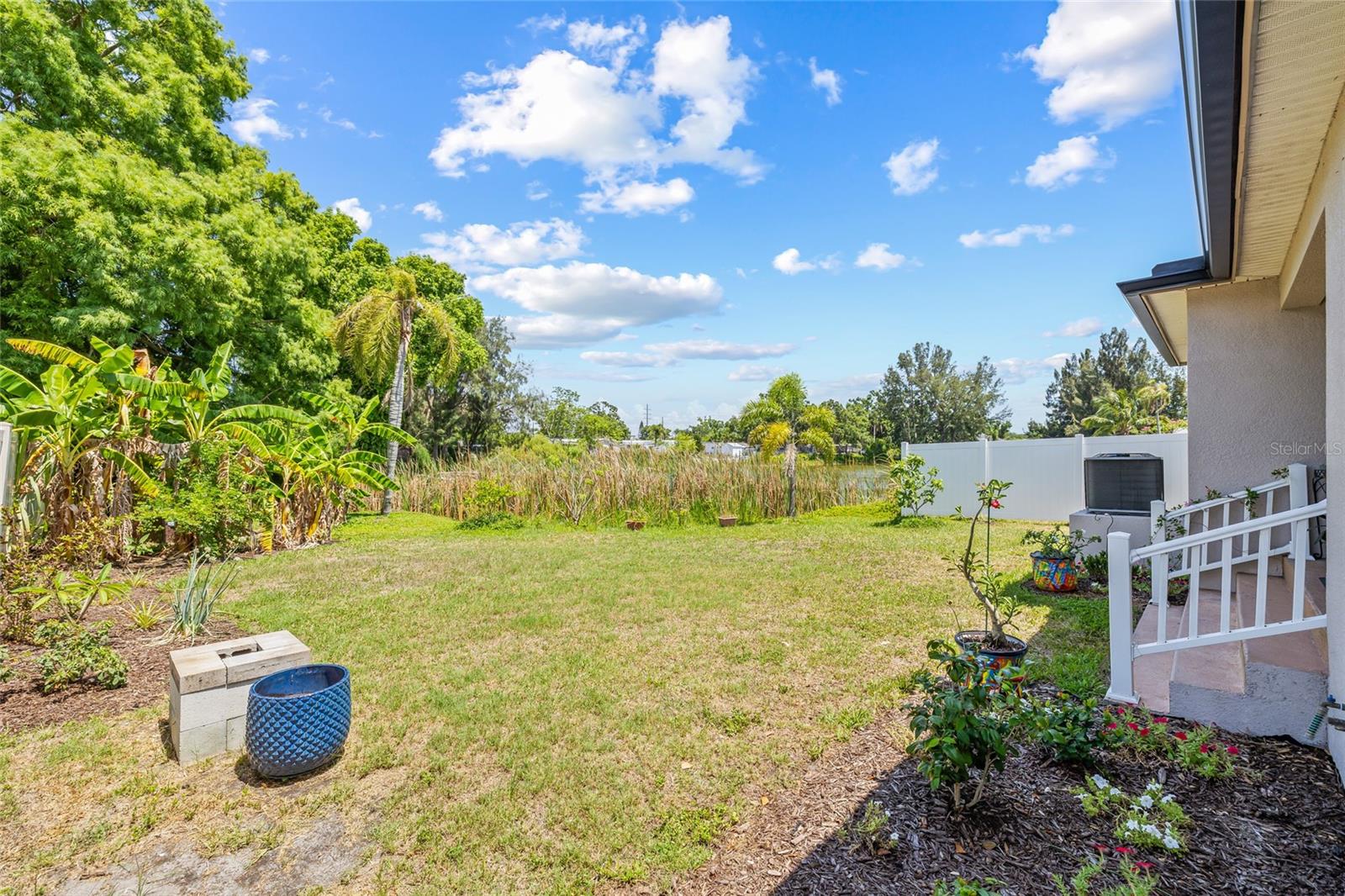 Imagine sunsets in this large fenced backyard with direct views of serene Orchid Lake. Add a fire pit, a hammock, or even a pool—your Florida dream starts here.