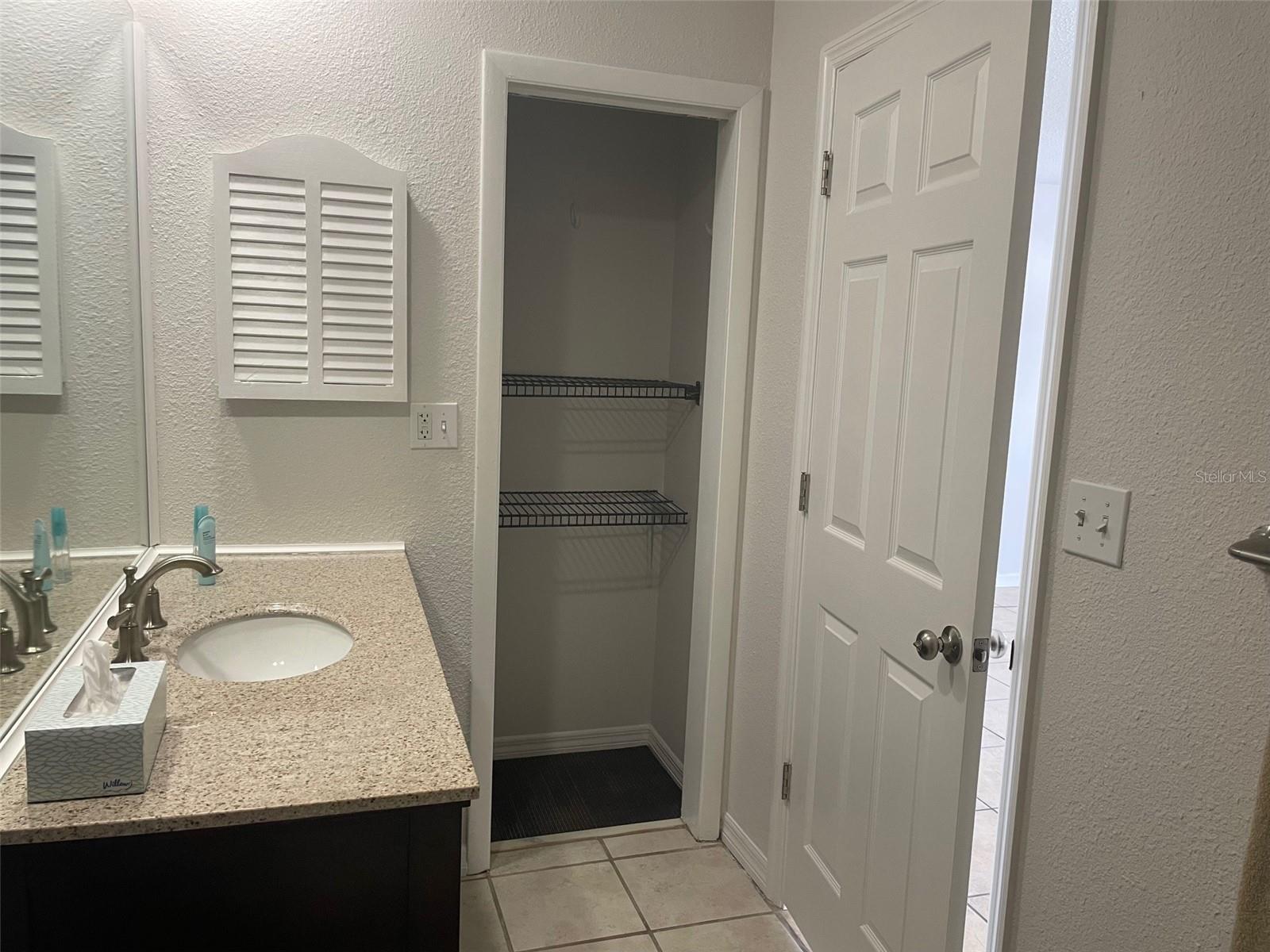 Ensuite bath showing extra closet space.