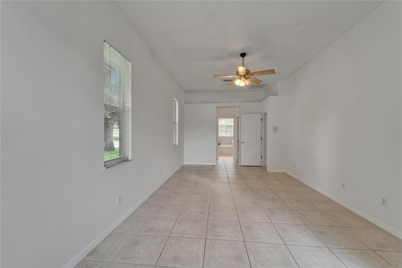 Primary suite entering en suite with closets on either side