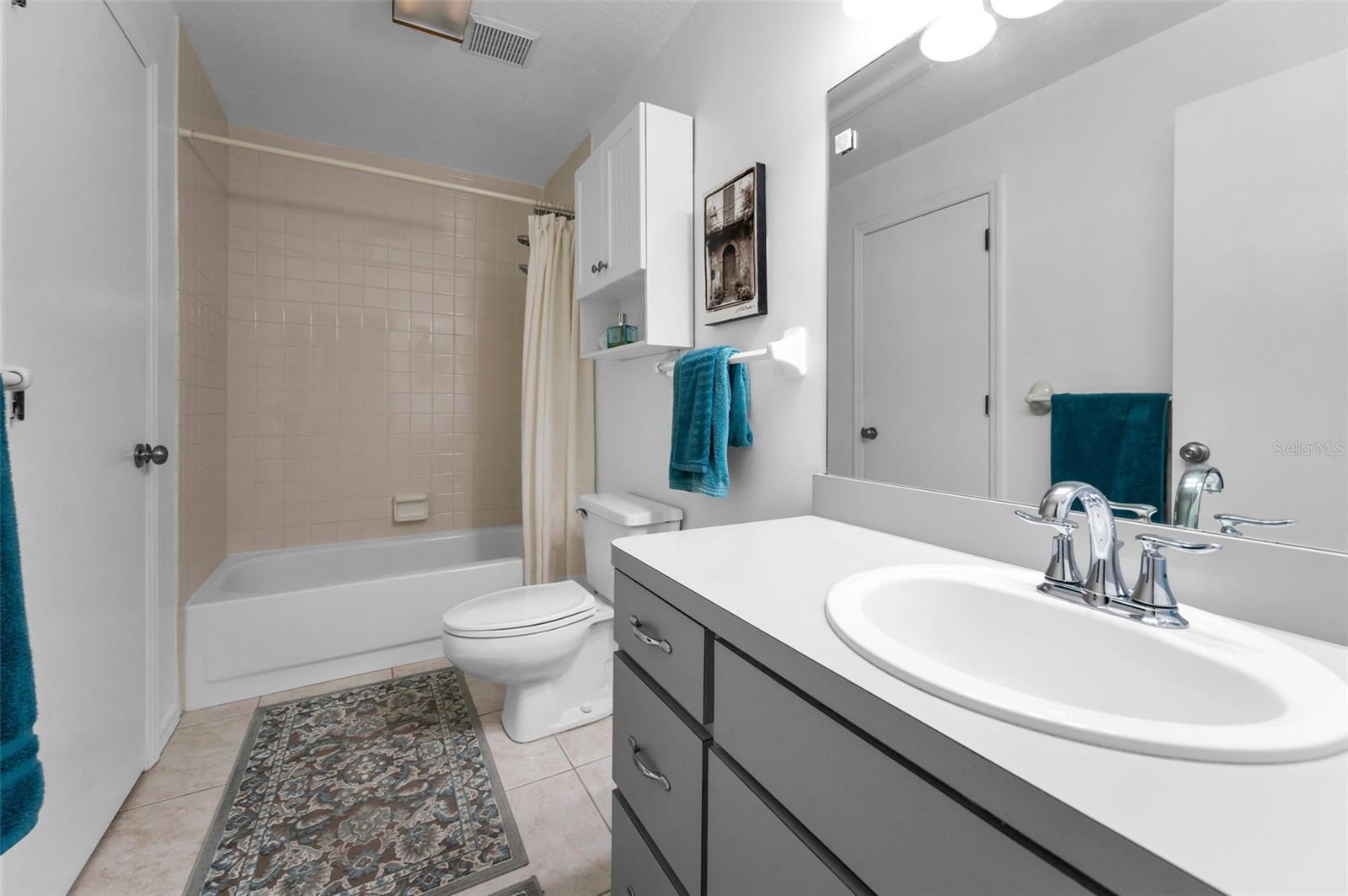 Bathroom is easily accessible from the primary bedroom AND the living room.