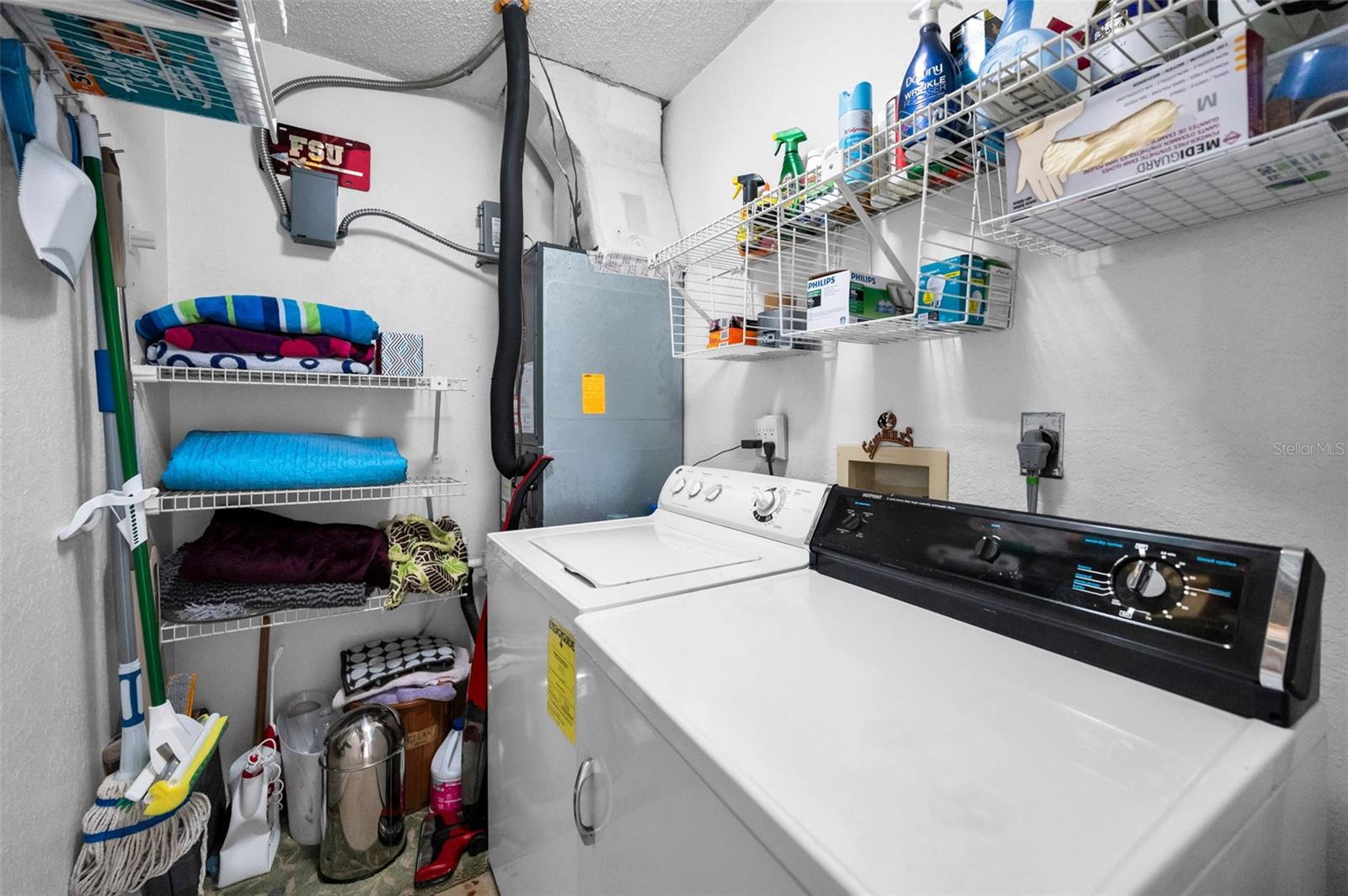 Inside laundry room with storage