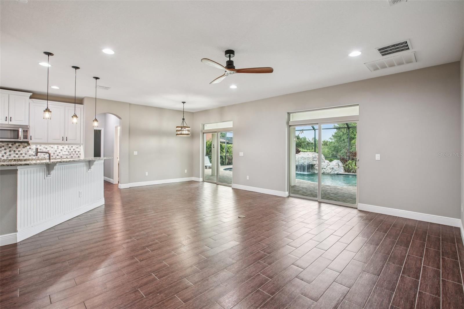 Open living with pool views