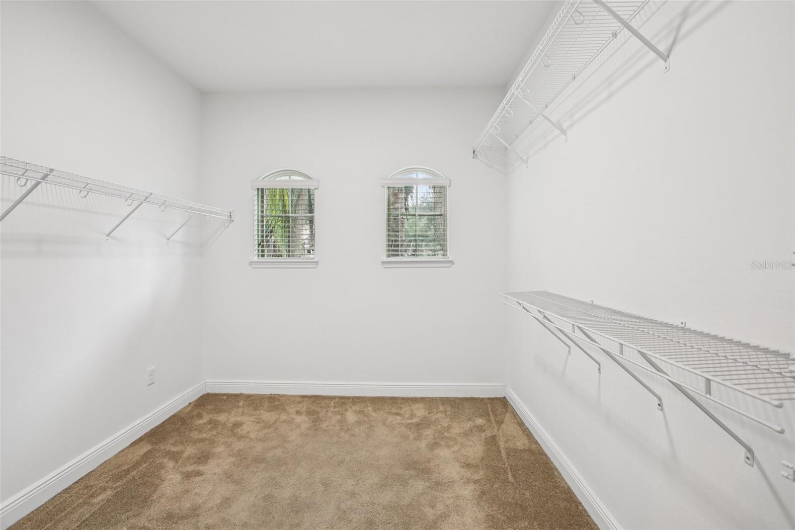 Spacious walk-in closet with windows