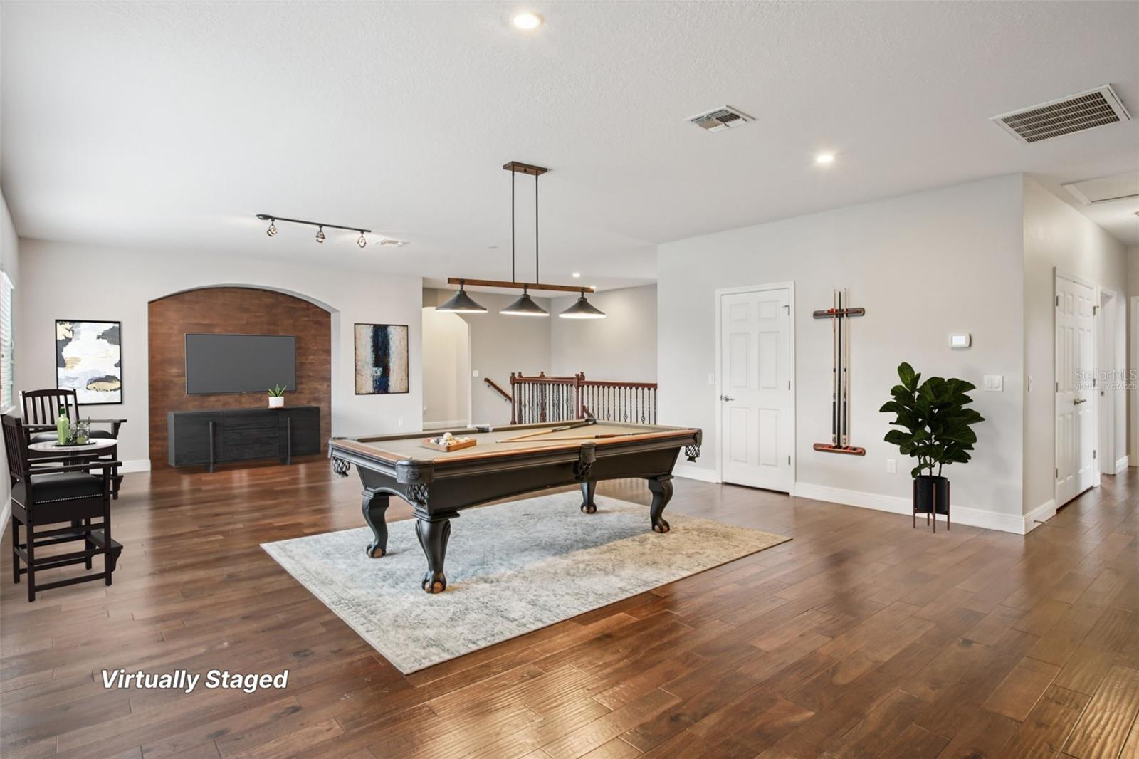 Virtually staged upstairs game room