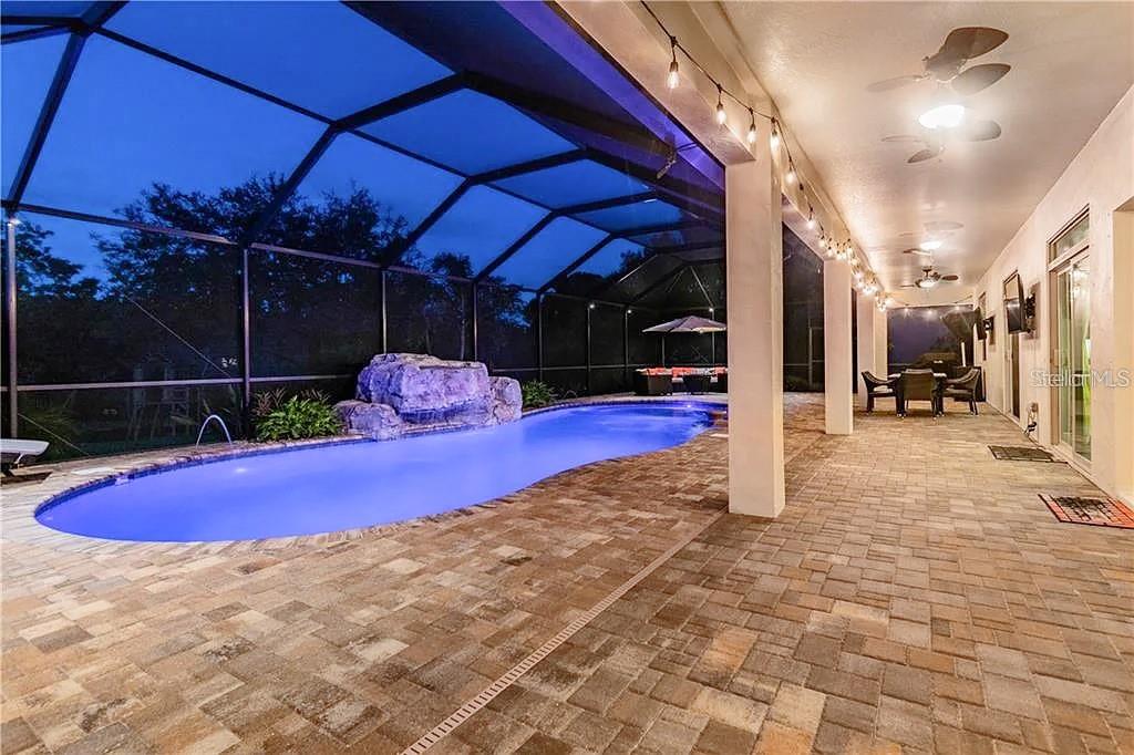 Covered lanai with lit pool ambiance