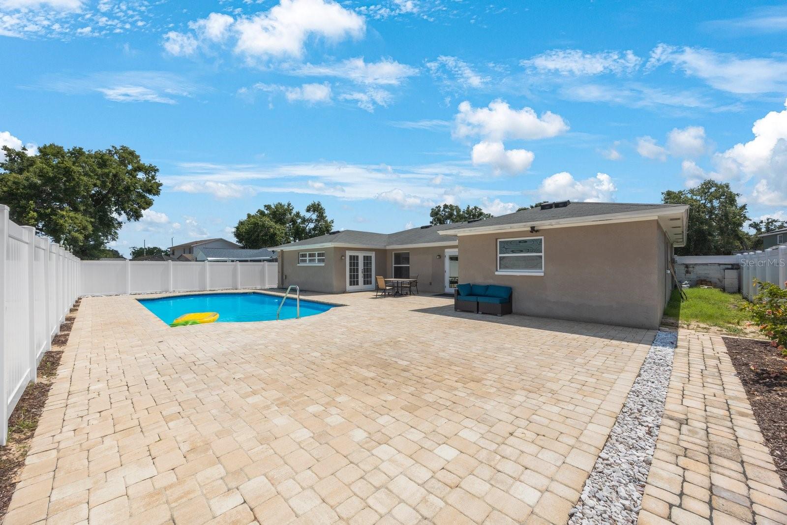 Paved back yard with the big pool!