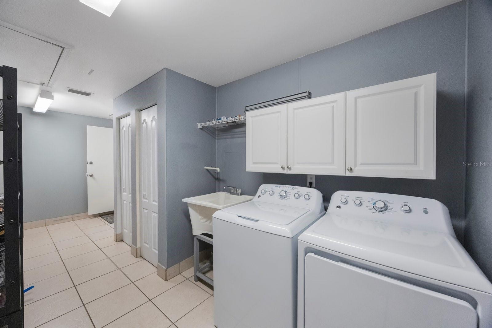 Big laundry room with a lot of storage space and a sink
