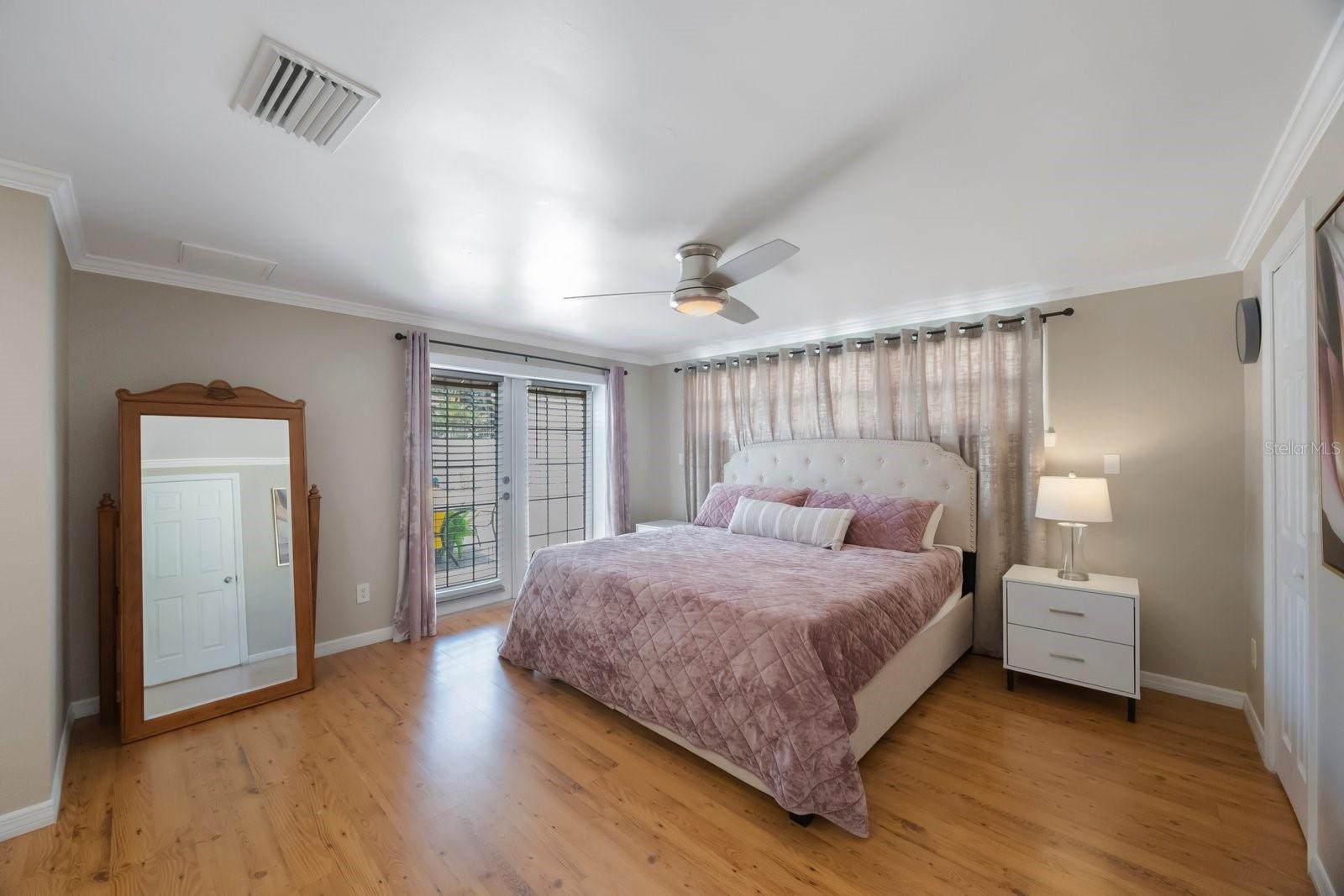 Master bedroom opens to the pool area. It has an en-suite bathroom and a walk-in closet.