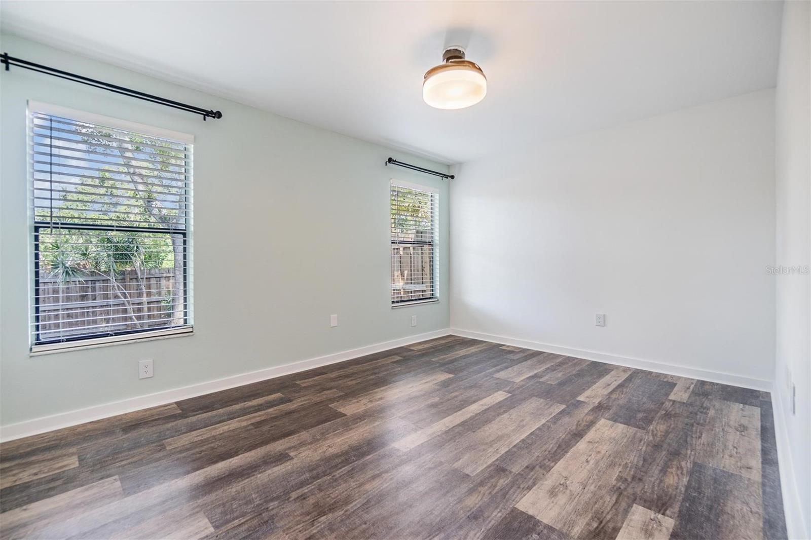 Larger third bedroom with walk-in closet and two large windows.