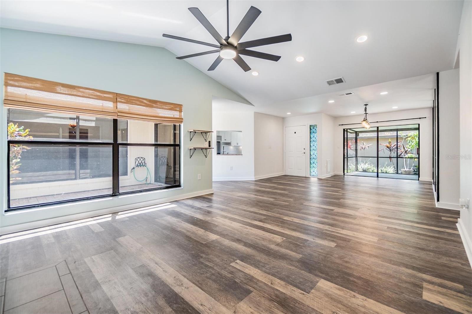 Enjoy views of the atrium from the living room and the oversized fan on the vaulted ceiling.