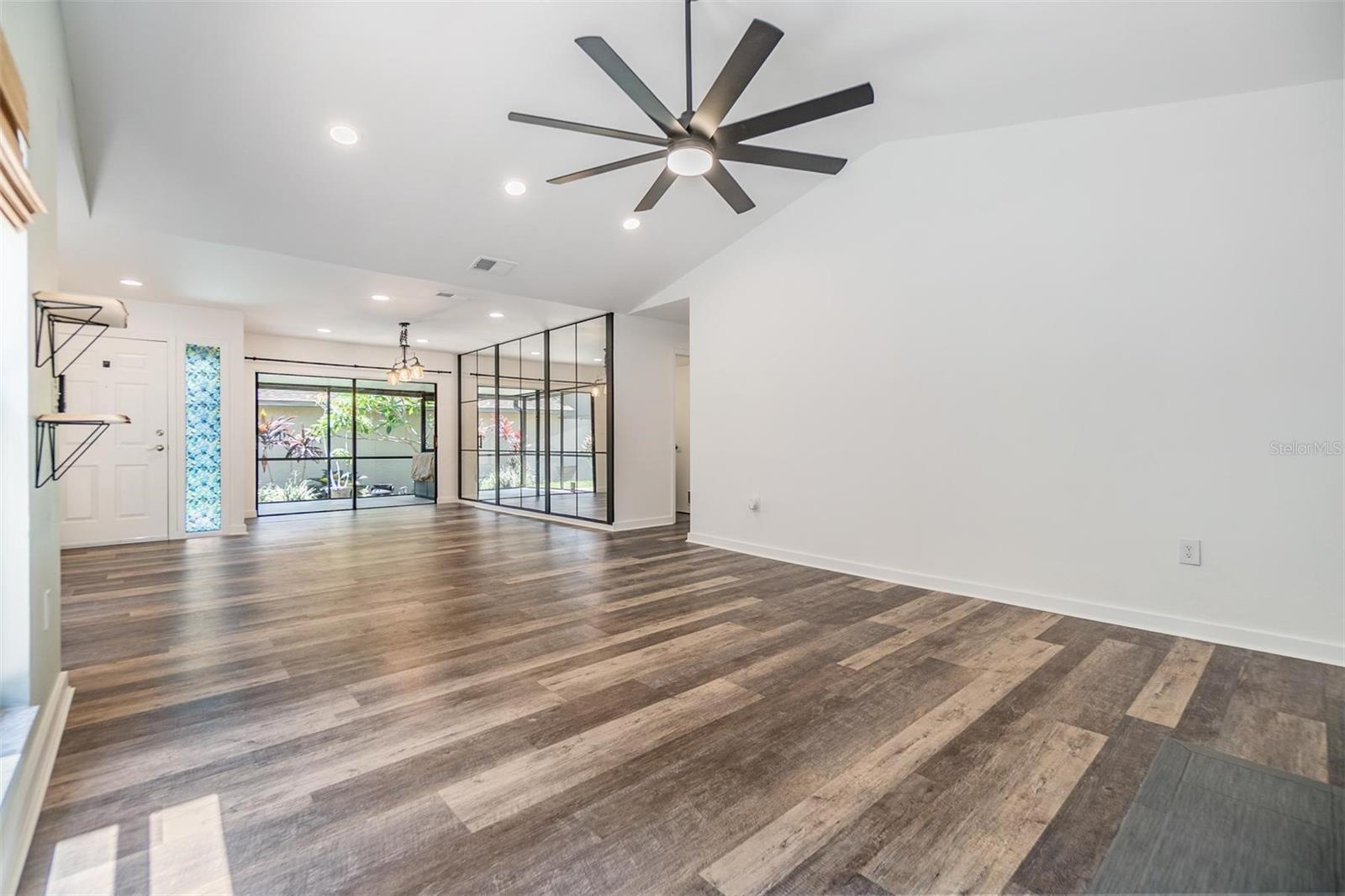 Large sliding glass doors out to the patio and decorative glass wall enhance the large feel of the dining room.