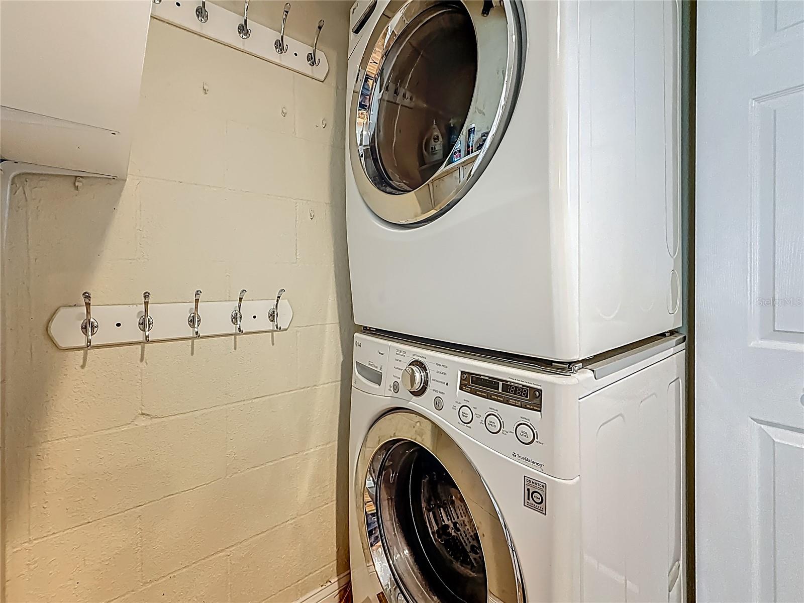 A large washer and dryer are in the laundry closet opposite the kitchen.