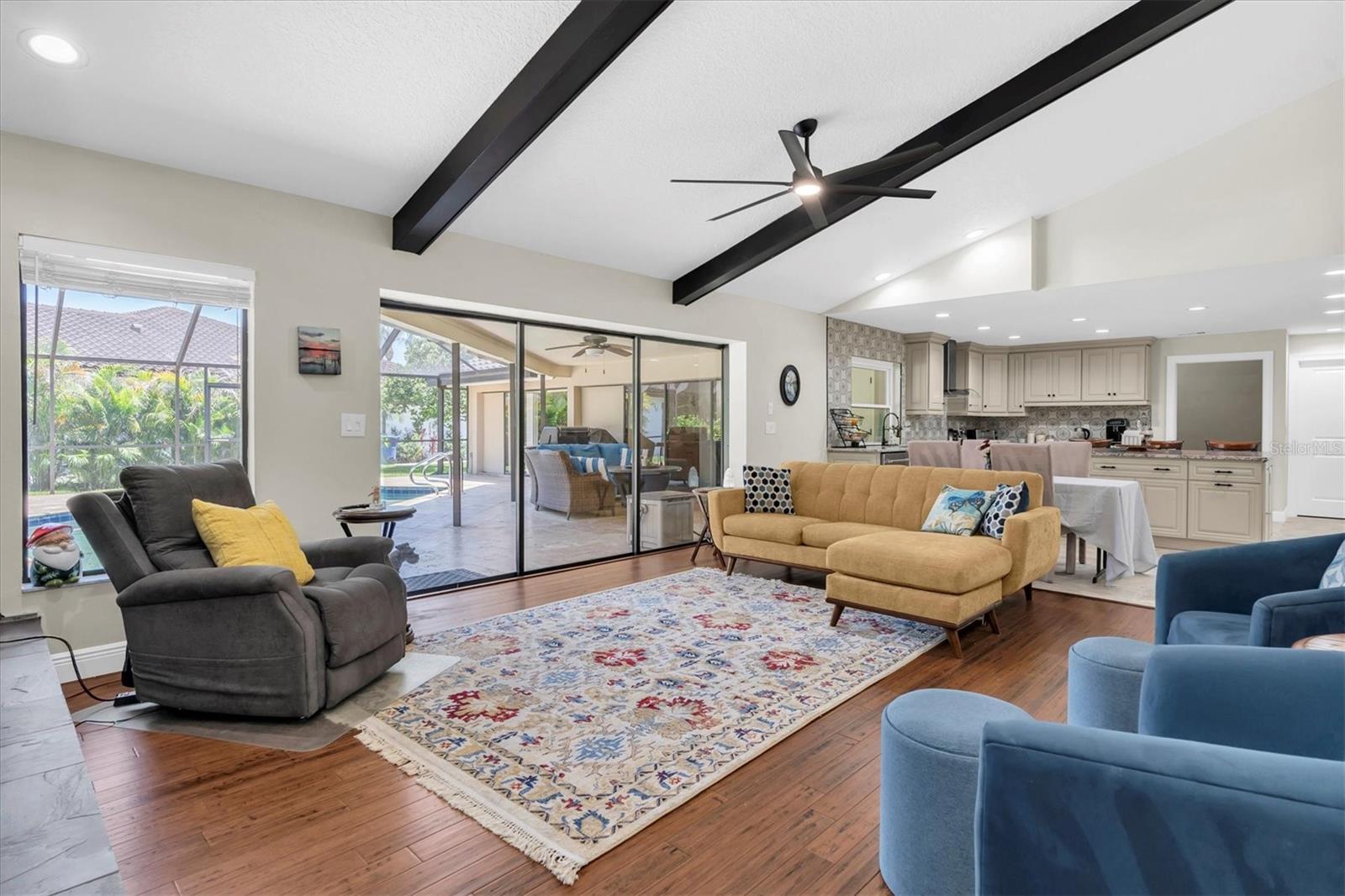 Living Room open to kitchen and pool views