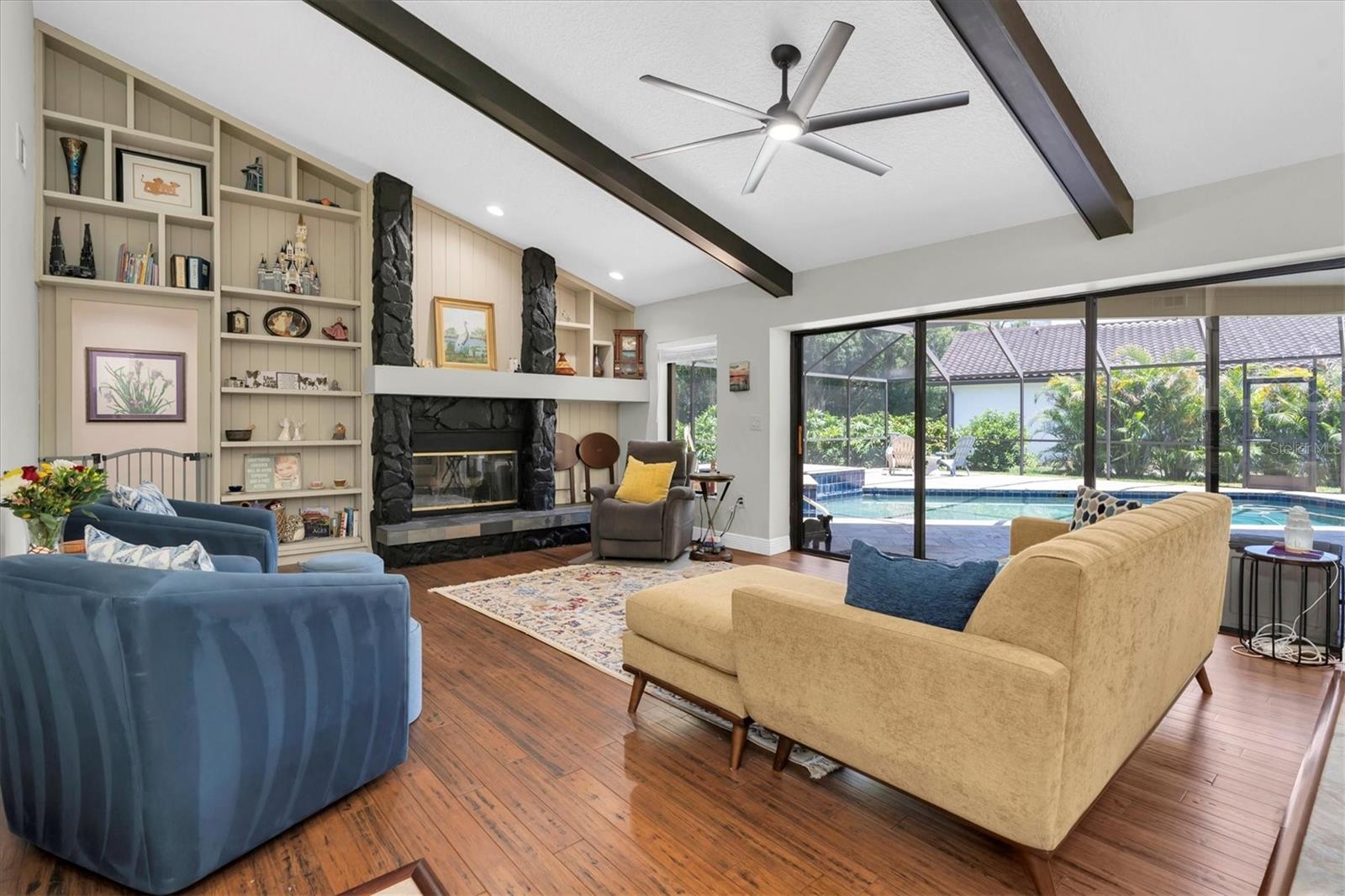Living Room open to kitchen and pool views