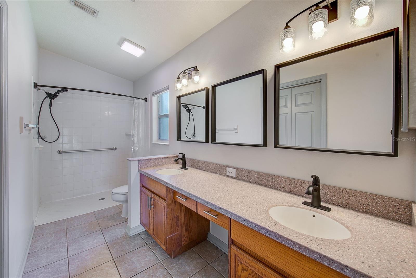 MASTER BATH WITH DUAL SINKS UPGRADED FIXTURES; SMART CONTROL LIGHTING; CORIAN COUNTERS; MIRROR SYSTEM & VANITY