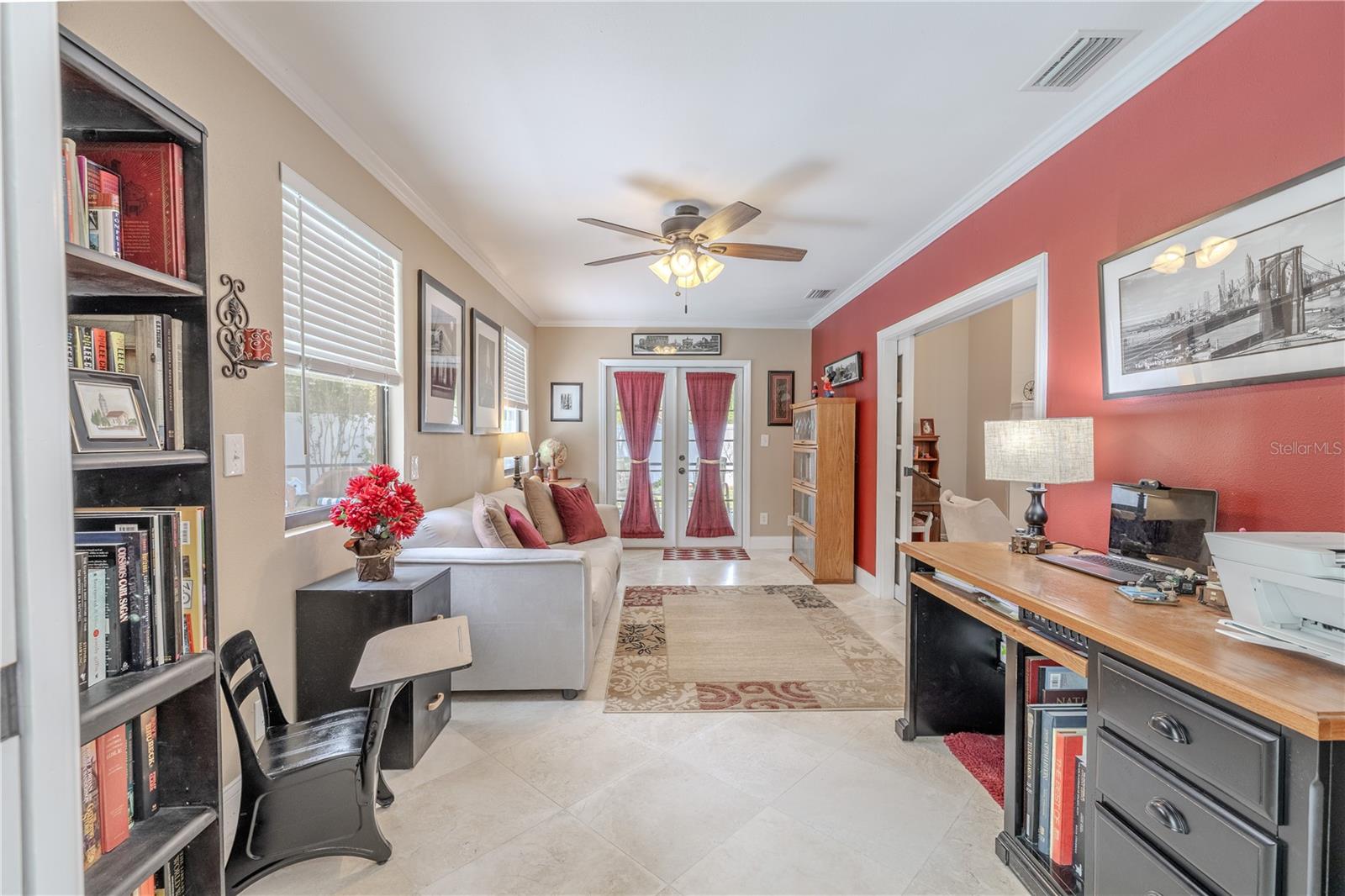 A bold accent wall adds a touch of personality, while multiple windows let in plenty of natural light and offer peaceful views of the fenced yard.
