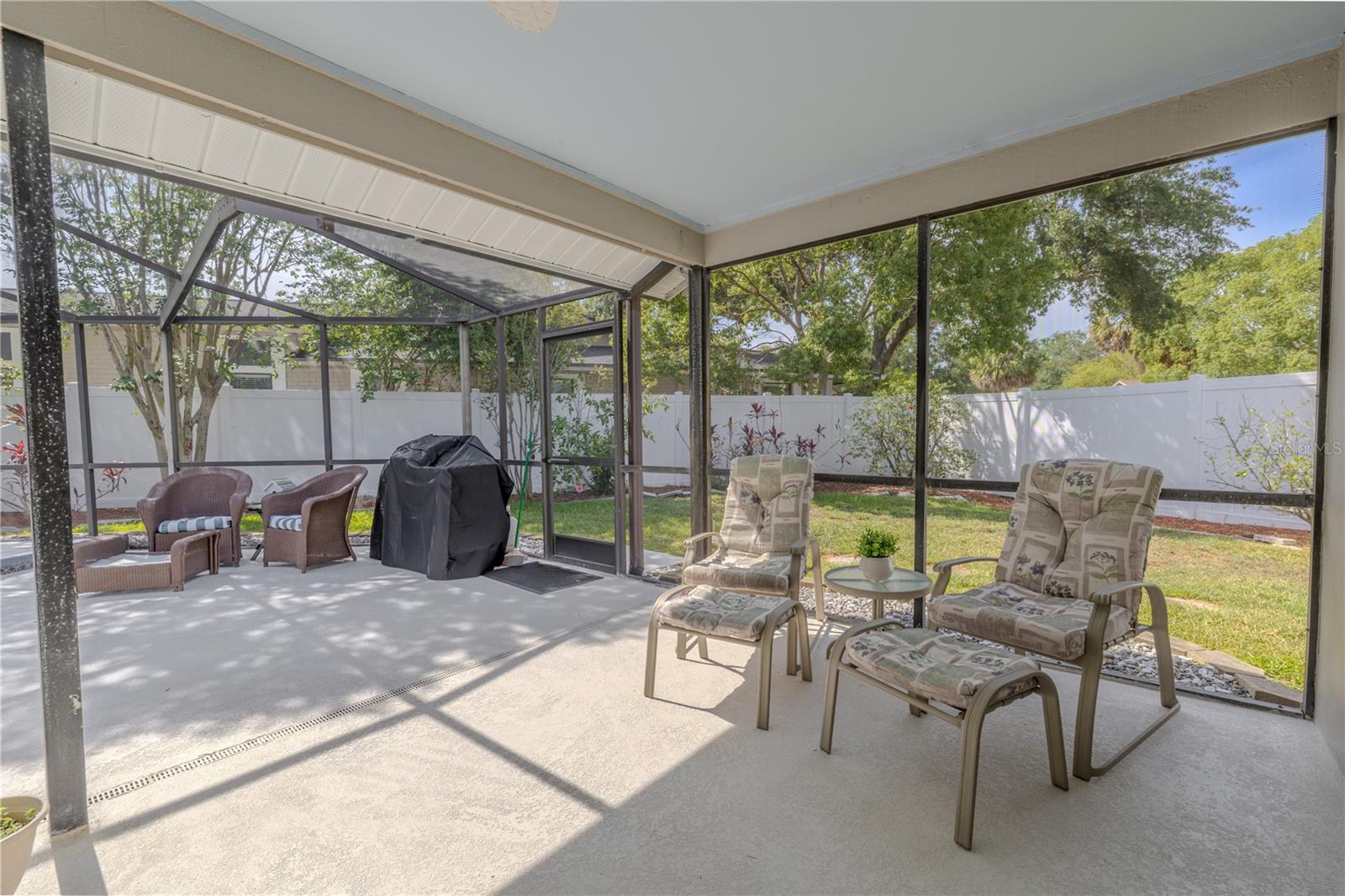 Surrounded by a spacious screen-enclosed lanai, this beautifully maintained area is designed for year-round enjoyment, whether you're swimming laps, lounging in the sun, or enjoying quiet mornings with coffee under the covered patio.