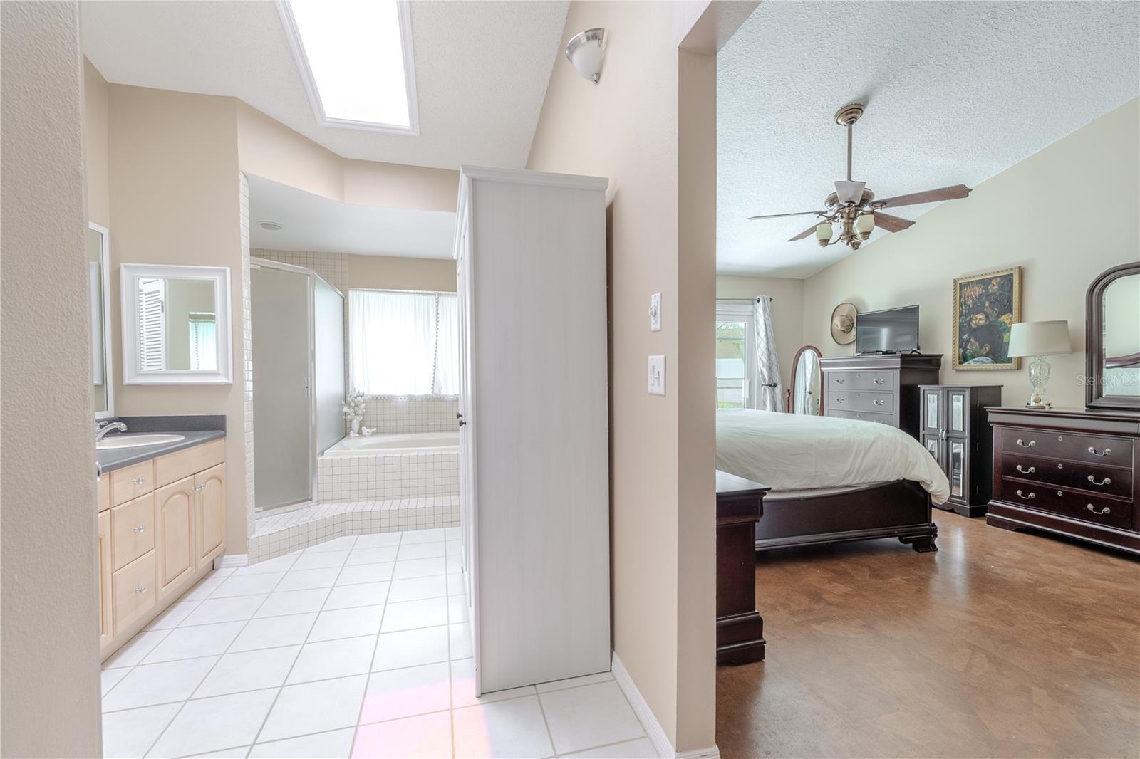 The en suite primary bathroom offers a spacious and private retreat designed for both function and relaxation.