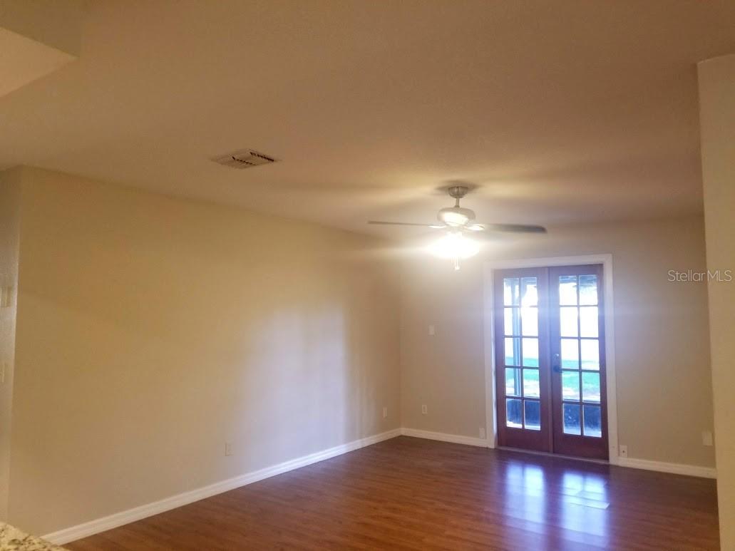 Double French doors of family room leading to screened porch