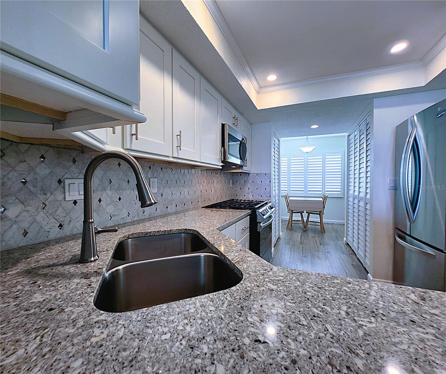 Kitchen: all featured appliances included, soft close cabinets, garbage disposal, granite countertop & stone backsplash