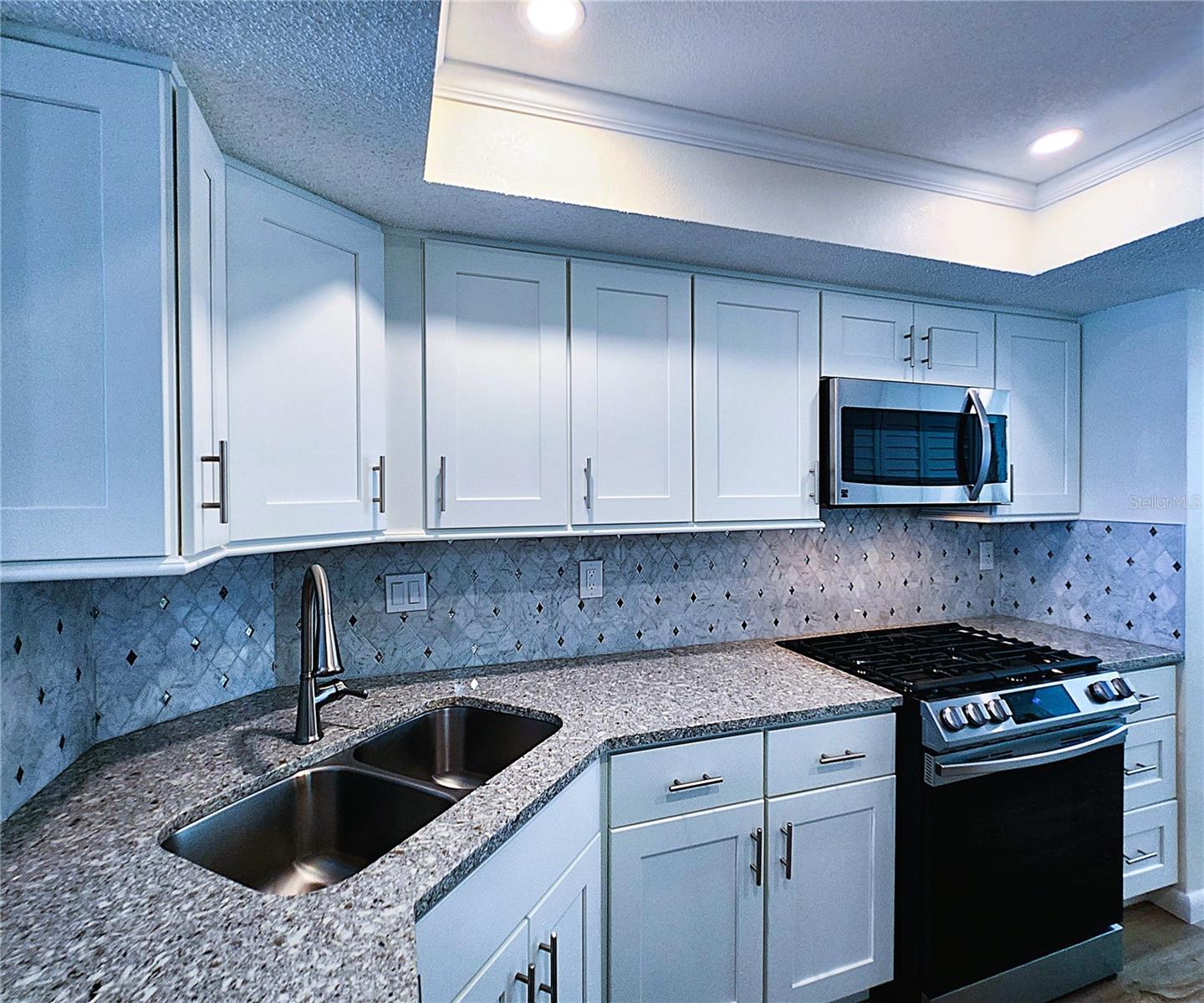 Kitchen: all featured appliances included, soft close cabinets, garbage disposal, granite countertop & stone backsplash
