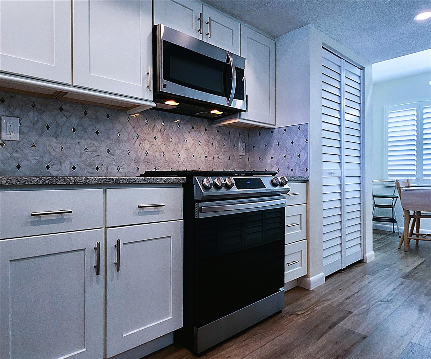Kitchen: all featured appliances included, soft close cabinets, garbage disposal, granite countertop & stone backsplash