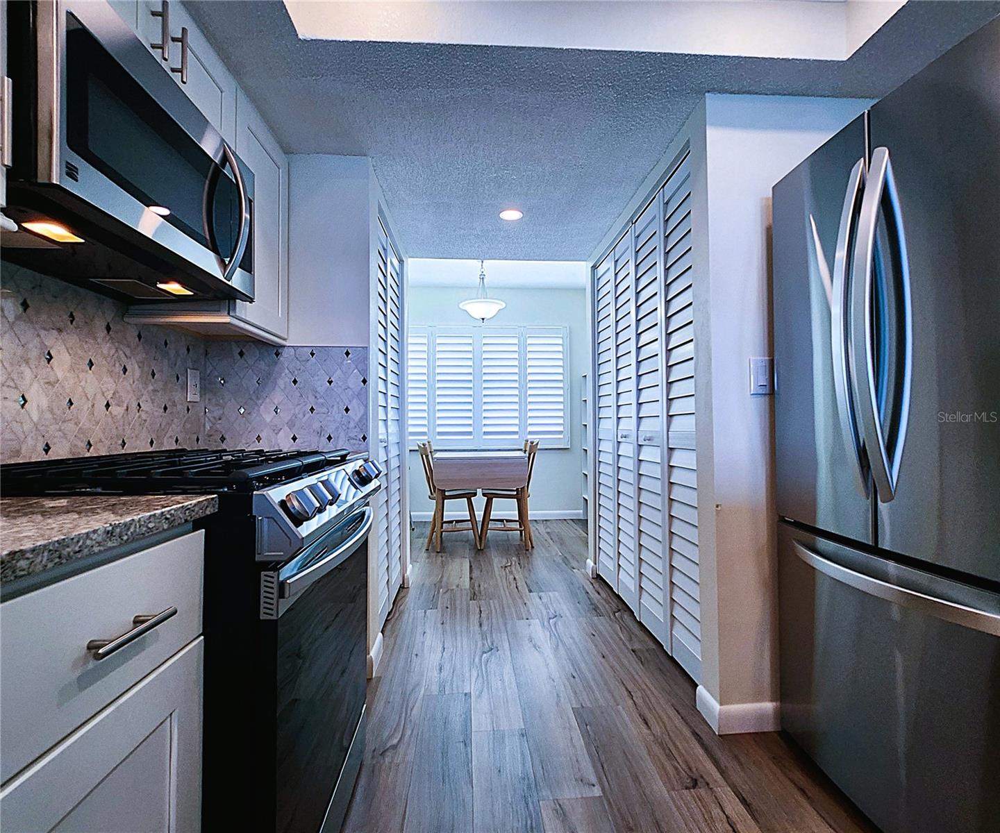 Kitchen: all featured appliances included, soft close cabinets, garbage disposal, granite countertop & stone backsplash