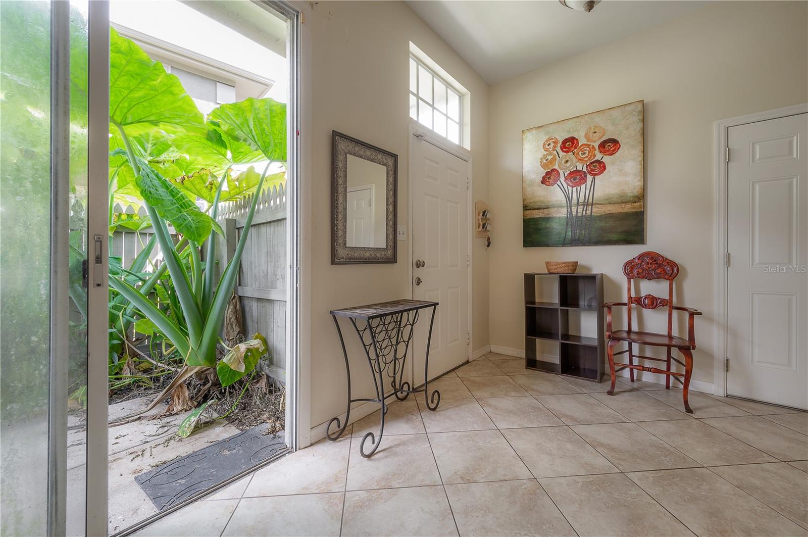 Entry foyer space leads to the fenced side patio