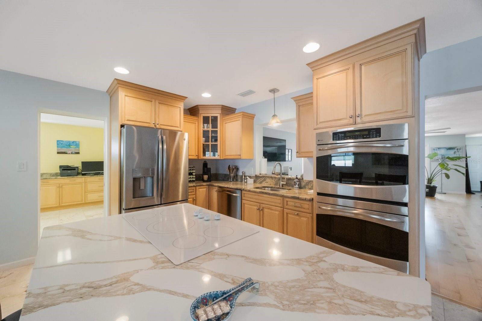 Unleash your inner chef in this well-appointed kitchen, featuring a stunning set of stainless steel double ovens! Perfect for preparing elaborate meals or holiday feasts, these ovens offer exceptional cooking capacity and flexibility, complemented by ample counter space and warm cabinetry