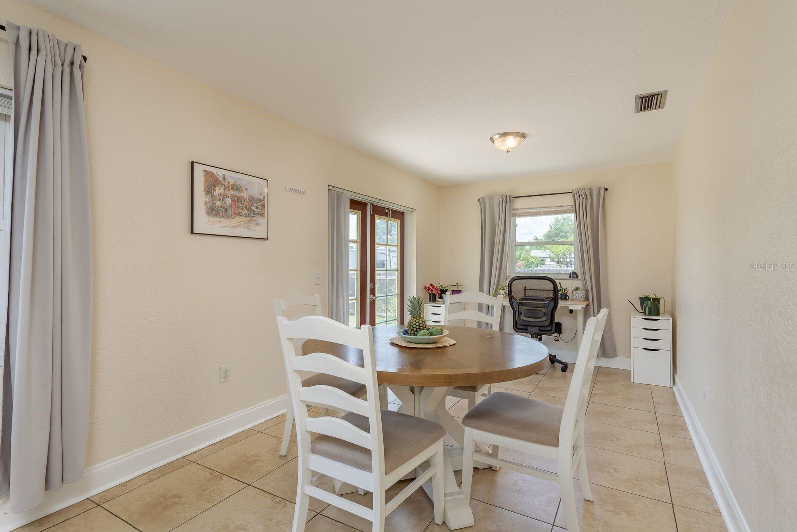 Dining room leads to french doors out to the backyard