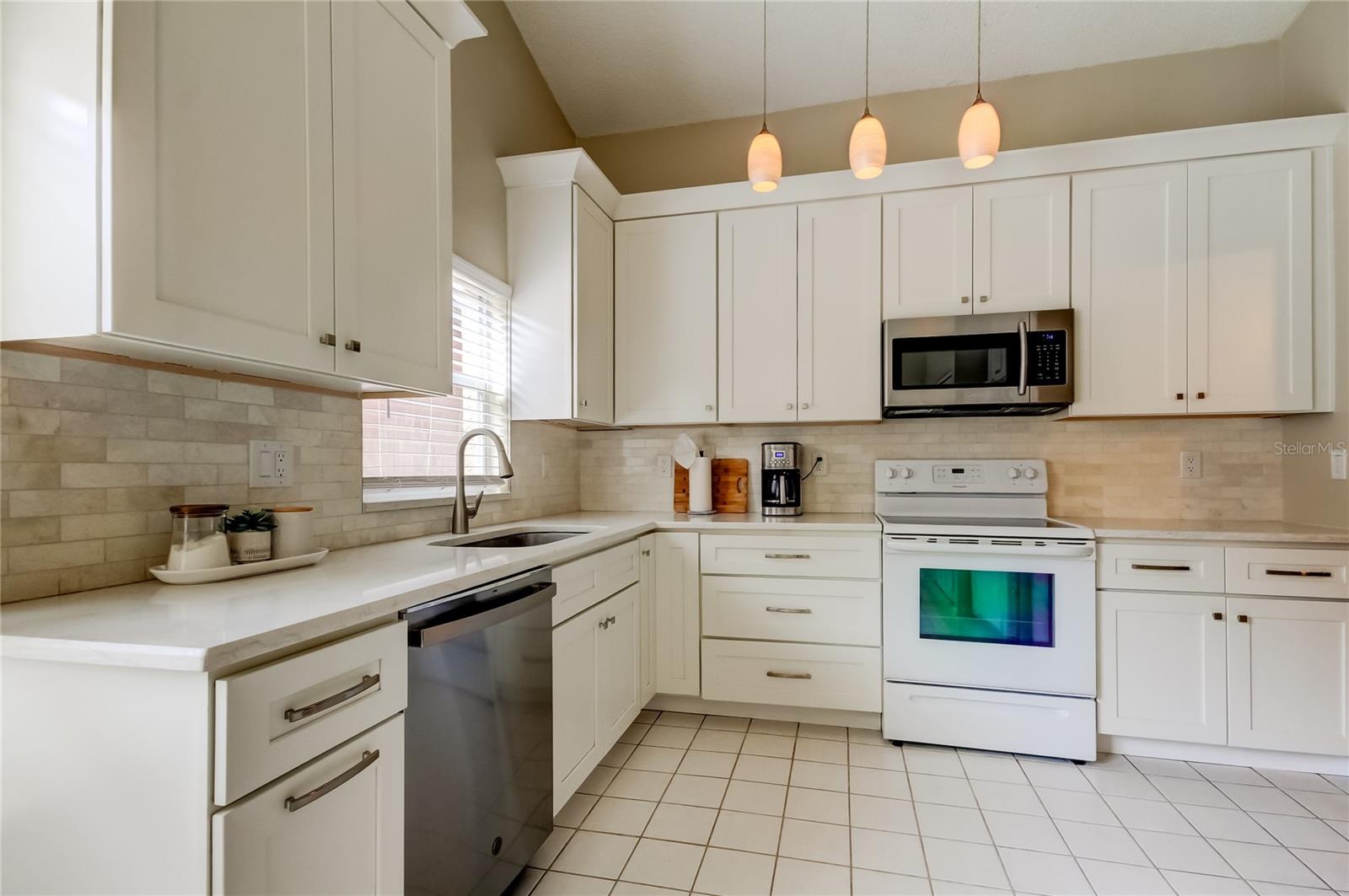 Updated kitchen with granite countertops and tile backsplash