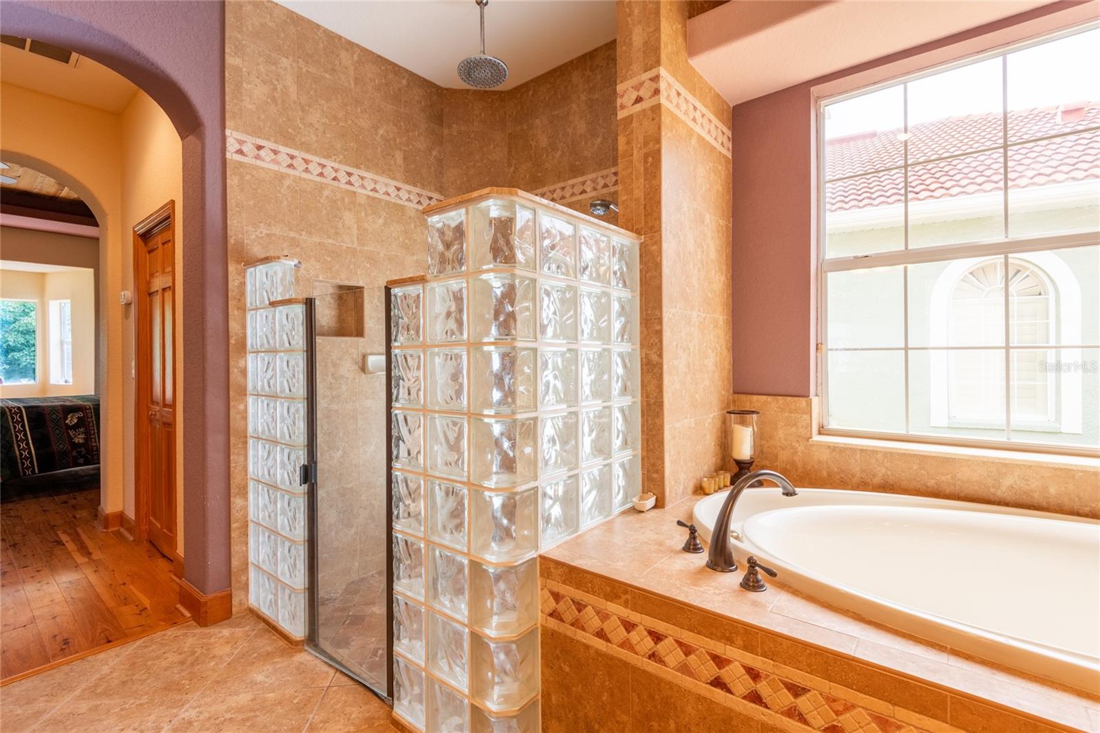 Beautiful glass block walk-in shower and Roman Garden Tub
