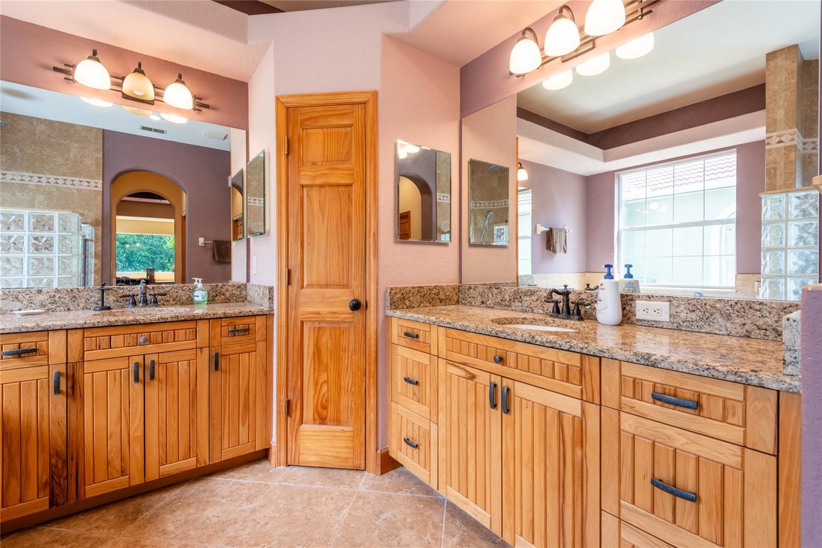 Master with his and her vanities and linen closet.