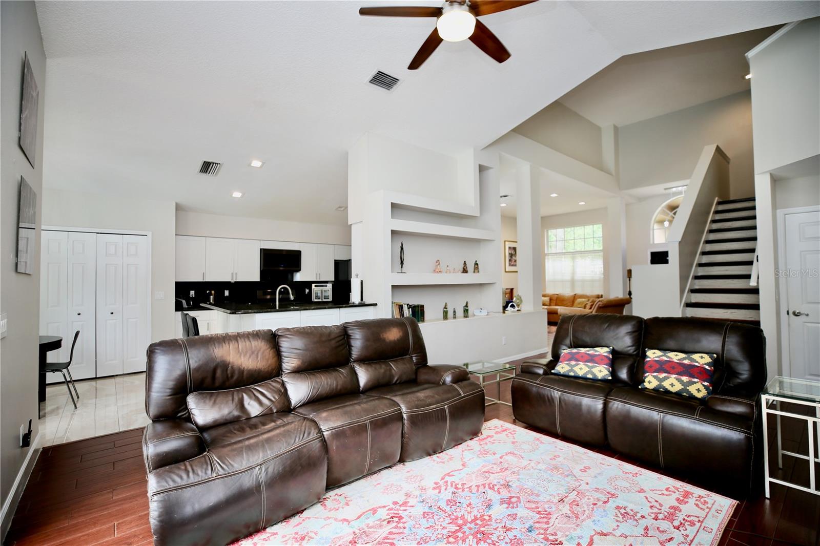 Family Room with high ceilings and wood tile flooring.