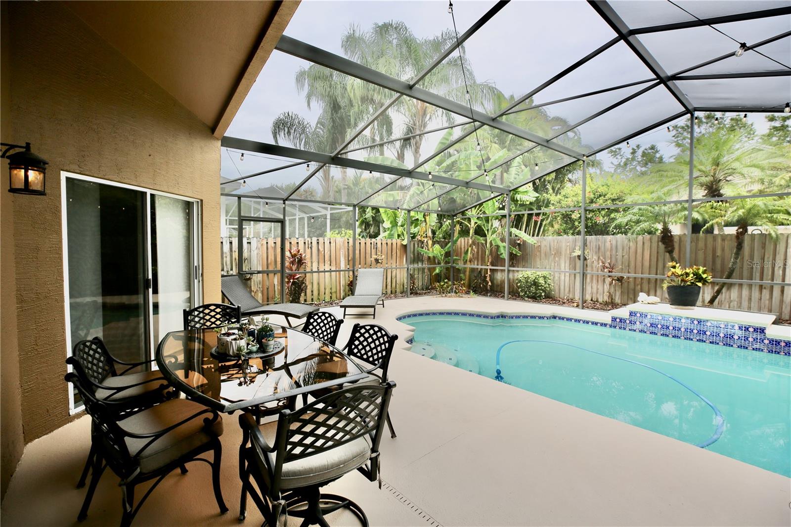 Pool Lanai with freshly painted cool deck perfectly landscaped with a Banana and Lemon Tree too.