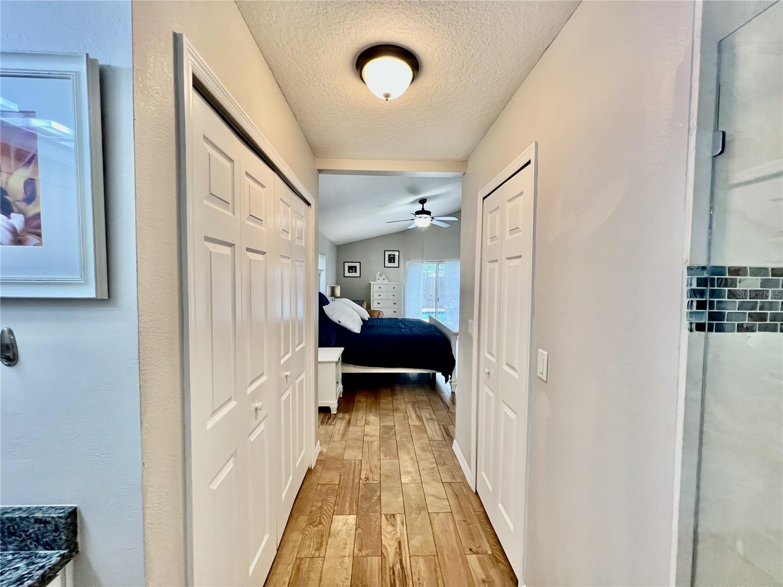 Hallway that has His & Her Closets.