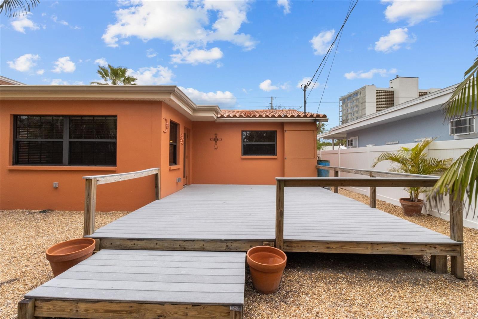 Enjoy your back yard oasis with this easy to maintain oversized composite deck  819 Gulf Blvd, a charming 2-bedroom, 1-bath ranch-style quaint Bungalow located just steps from beach access on the stunning shores of Indian Rocks Beach, Indian Rocks Beach Nature Preserve with public dog park and a Boardwalk to through the Mangroves on the Intercoastal.