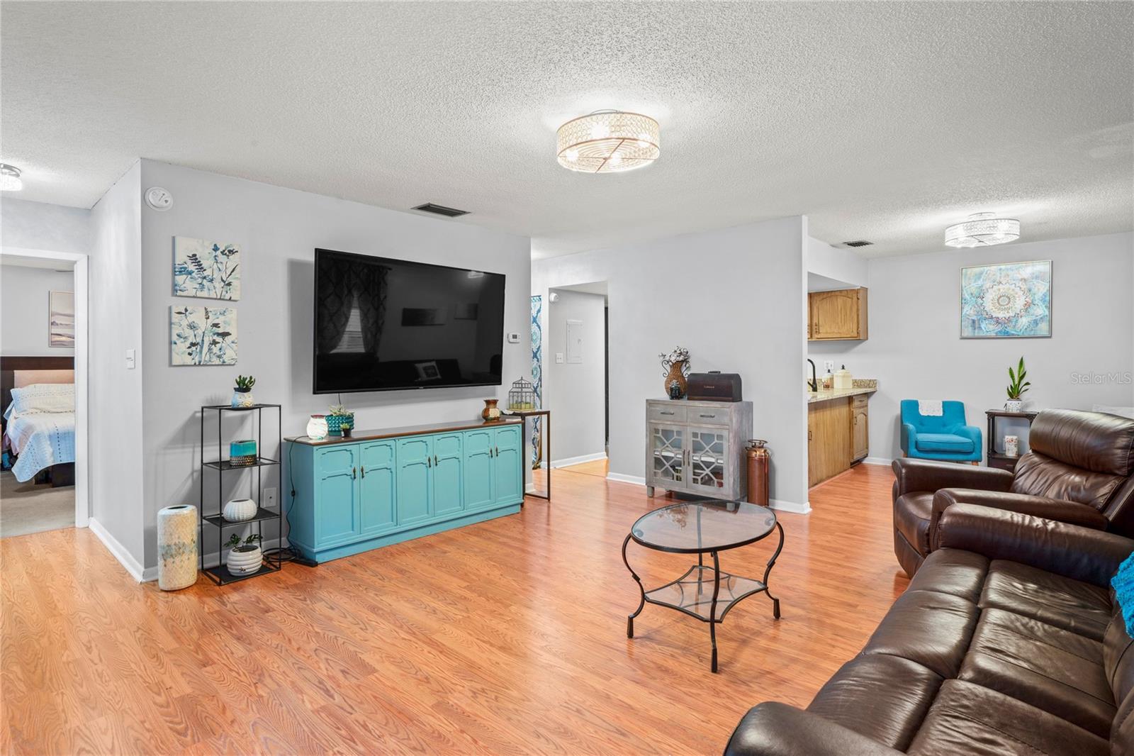 Living Room looking into Primary Bedroom & Kitchen